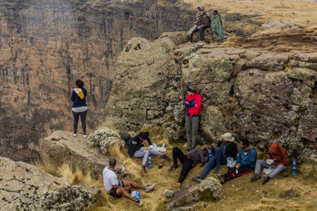 SIMIEN MOUNTAINS, ETHIOPIA - MARCH 16, 2019: Tourists looking into the northern escarpment in Simien...
