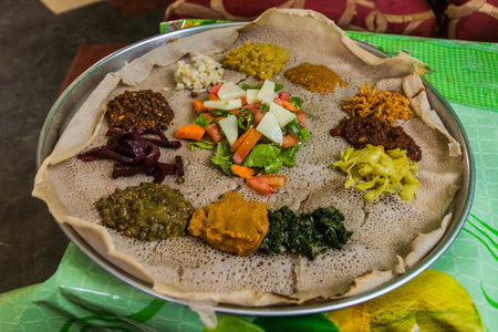 Typical meal in Ethiopia - Beyainatu. Meaing bit of everything. Mix of vegetables and stews on injera flatbread.の写真素材