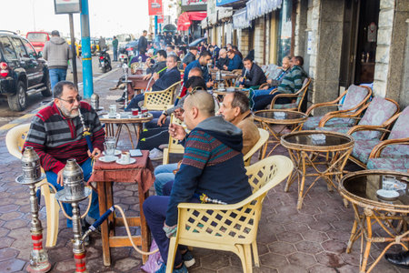 ALEXANDRIA, EGYPT - FEBRUARY 1, 2019: People in a traditional street cafe in Alexandria, Egypt