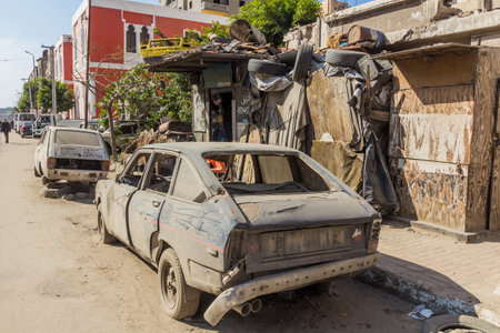 ALEXANDRIA, EGYPT - FEBRUARY 2, 2019: Wrecked old cars on a street in Alexandria, Egyptの写真素材