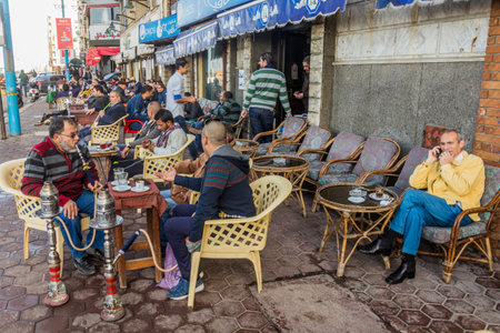 ALEXANDRIA, EGYPT - FEBRUARY 1, 2019: People in a traditional street cafe in Alexandria, Egypt