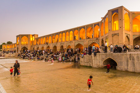 ISFAHAN, IRAN - JULY 9, 2019: People enjoying evening at Khaju bridge in Isfahan, Iran