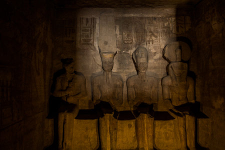 Statues of Ptah, Amun Ra, king Ramesses II and Ra-Horakhty illuminated by the rays of the sun in the...