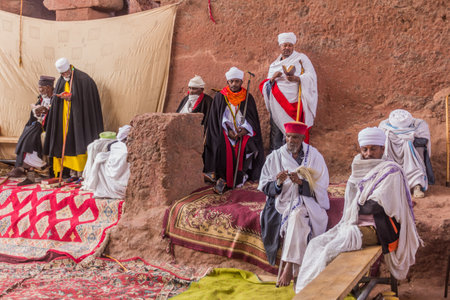 LALIBELA, ETHIOPIA - MARCH 29, 2019: Christian priests in front of Bet Maryam, rock-cut church in Lalibela, Ethiopiaのeditorial素材