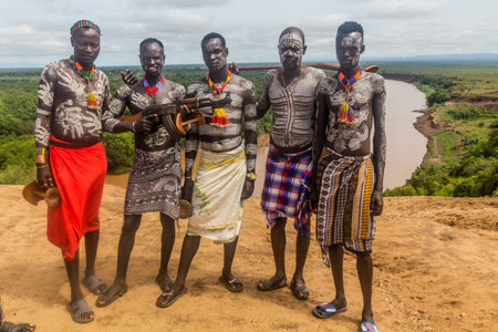 KORCHO, ETHIOPIA - FEBRUARY 4, 2020: Members of Karo tribe above Omo river near Korcho village,...