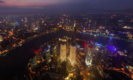 Night aerial view of skyscrapers in Shanghai with Huangpu river, Chinaの写真素材