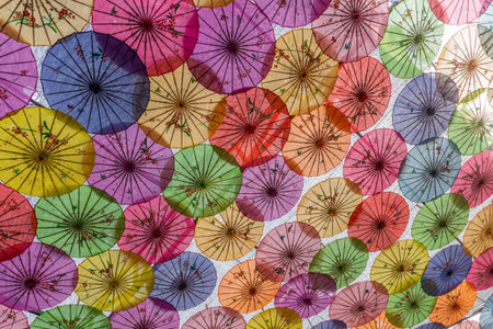 Colorful umbrellas covering a courtyard in Chinaの写真素材