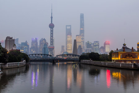 Skyscrapers of Pudong behind historical Waibaidu bridge in Shanghai, China