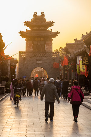PINGYAO, CHINA - OCTOBER 20, 2019: Sunset view of a gate in Pingayo Ancient City, Chinaの写真素材