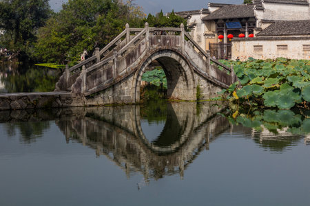 Bridge over South lake in Hongcun village, Anhui province, Chinaの写真素材