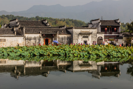 HONGCUN, CHINA - OCTOBER 29, 2019: Houses of Hongcun village reflecting in South lake, Anhui province, Chinaのeditorial素材