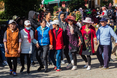 LIJIANG, CHINA  - NOVEMBER 8, 2019: Local people dance in the old town of Lijiang, Yunnan province, Chinaのeditorial素材