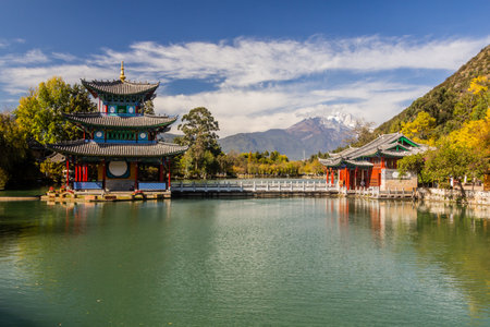 Jade Dragon Snow Mountain behind Black Dragon Pool in Lijiang, Yunnan province, Chinaの写真素材