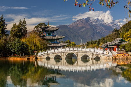 Jade Dragon Snow Mountain behind Black Dragon Pool in Lijiang, Yunnan province, Chinaの写真素材