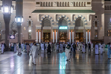 MEDINA, SAUDI ARABIA - NOVEMBER 12, 2021: Devotees on the grounds of the Prophet's Mosque in Al...