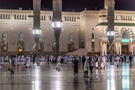 MEDINA, SAUDI ARABIA - NOVEMBER 12, 2021: Devotees on the grounds of the Prophet's Mosque in Al...