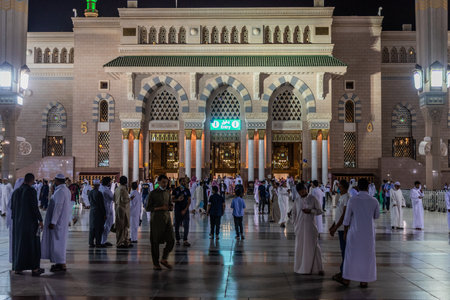 MEDINA, SAUDI ARABIA - NOVEMBER 12, 2021: Devotees in front of the Prophet's Mosque in Al Haram area...