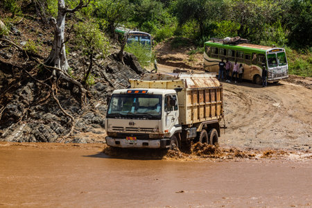 OMO VALLEY, ETHIOPIA - FEBRUARY 4, 2020: Truck crossing Kizo river, Ethiopia