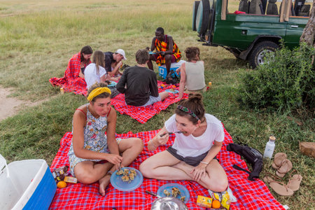 MASAI MARA, KENYA - FEBRUARY 19, 2020: Safari ride participants having lunch in Masai Mara National Reserve, Kenyaのeditorial素材