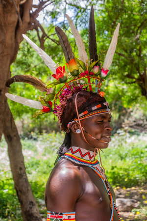 SOUTH HORR, KENYA - FEBRUARY 12, 2020: Samburu tribe young man wearing a colorful headpiece made of...
