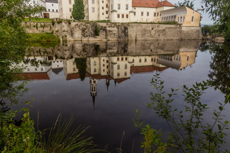 View of Vyssi Brod monastery reflecting in a water, Czech Republicの写真素材