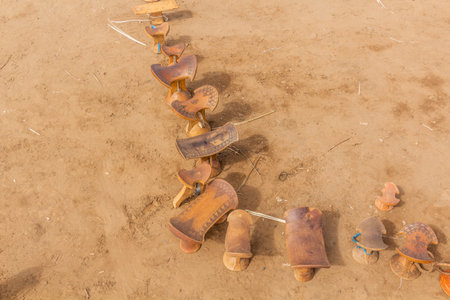 Daasanach tribe-made wooden seats for sale in their village near Omorate, Ethiopia