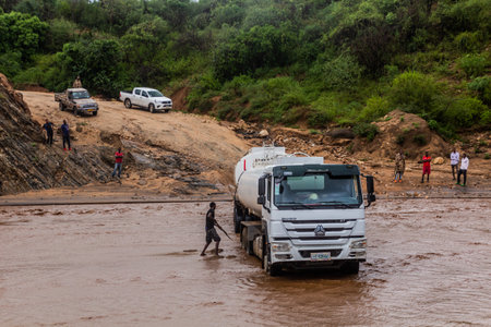 OMO VALLEY, ETHIOPIA - FEBRUARY 4, 2020: Truck stuck in swollen waters of Kizo river, Ethiopia
