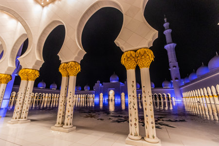 Night view of the courtyard of Sheikh Zayed Grand Mosque in Abu Dhabi, United Arab Emirates.