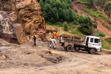 KABALE, UGANDA - MARCH 18, 2020: Local people excavating stone in a quarry near Kabale, Ugandaのeditorial素材