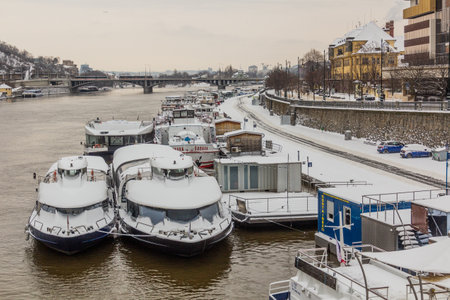 PRAGUE, CZECHIA - FEBRUARY 8, 2021: Winter view of boats at Vltava river in Prague, Czech Republicのeditorial素材