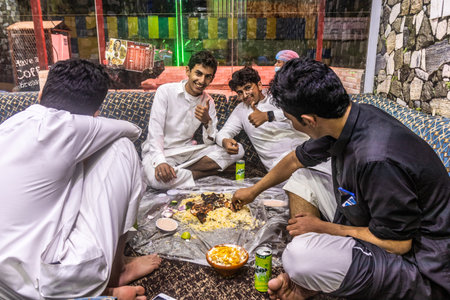 FAYFA, SAUDI ARABIA - NOVEMBER 23, 2021: People eating in a local restaurant in Fayfa town, Saudi Arabiaのeditorial素材