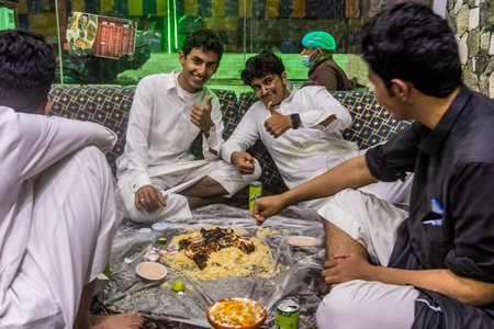 FAYFA, SAUDI ARABIA - NOVEMBER 23, 2021: People eating in a local restaurant in Fayfa town, Saudi Arabiaのeditorial素材
