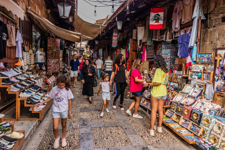 BYBLOS, LEBANON - JULY 30, 2022: Narrow cobbled street with souvenir stalls in Byblos, Lebanon