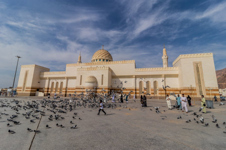 MEDINA, SAUDI ARABIA - NOVEMBER 12, 2021: Pigeons in front of the Masjid al-Shuhada mosque under...