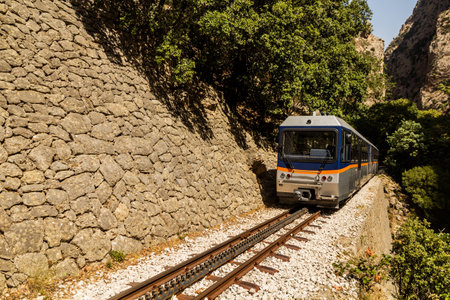 Train at narrow gauge Odontotos railway in Vouraikos Gorge on Peloponnese peninsula, Greece.