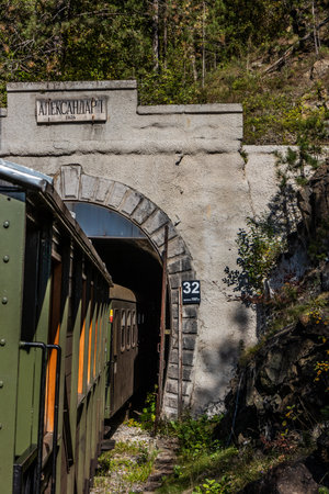 MOKRA GORA, SERBIA - OCTOBER 5, 2021: Train entering Alexander I tunnel on Sarganska Osmica (Sargan Eight) narrow-gauge heritage railway, Serbiaのeditorial素材