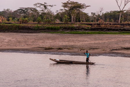 MOMPOX, COLOMBIA - MARCH 3, 2023: Local man on a boat on Magdalena river in Santa Cruz de Mompox, Colombiaのeditorial素材