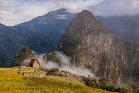 Early morning misty view of Machu Picchu ruins, Peru