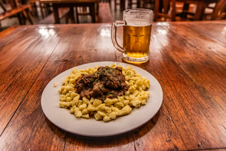 German meal in Pozuzo village, Peru. Goulash with spaetzle and a beer.の写真素材