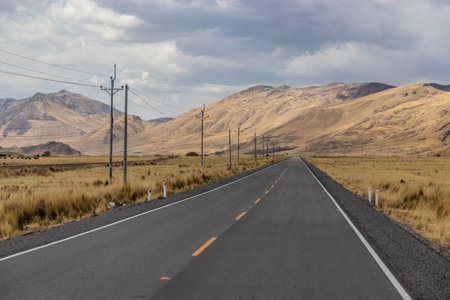 Road 3S and a railway Puno - Cuzco across Altiplano Andean Plateau in Peru
