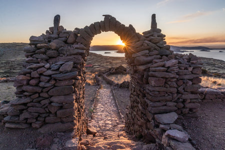 Sunset view of a stone gateway on Pachatata hill on Amantani island in Titicaca lake, Peruの写真素材