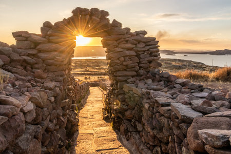 Sunset view of a stone gateway on Pachatata hill on Amantani island in Titicaca lake, Peruの写真素材