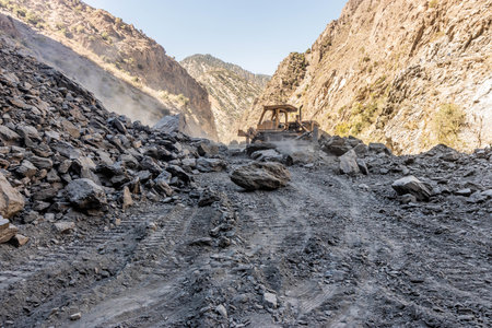Machinery clearing a landslide on a narrow road in Kalash valley, Pakistan