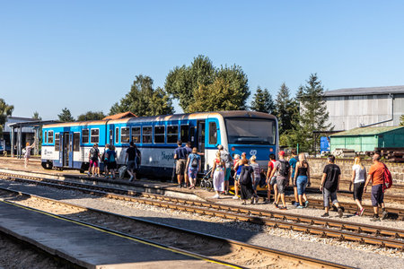 BLATNA, CZECH REPUBLIC - SEPTEMBER 9, 2023: Passengers boarding a RegioNova train of Czech Railways...