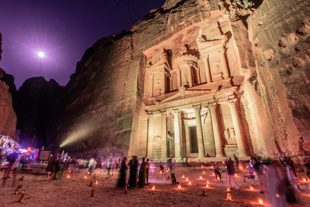 PETRA, JORDAN - JULY 11, 2022: People at the illuminated Al Khazneh temple (The Treasury) in the ancient city Petra, Jordanのeditorial素材