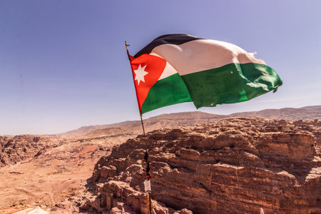 Flag of Jordan above the ancient city Petra, Jordan