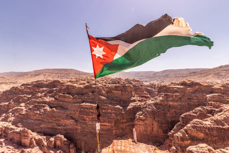 Flag of Jordan above the ancient city Petra, Jordan
