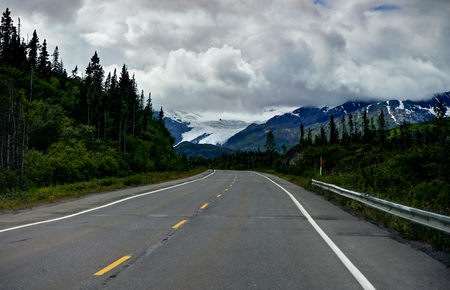Empty street with view towards Glacier mountain panoarama in Alaの写真素材