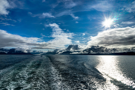 Mountains covered in clouds on a misty morning on the Ferry towaの写真素材