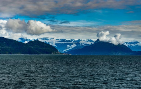 Mountains covered in clouds on a misty morning on the Ferry towaの写真素材
